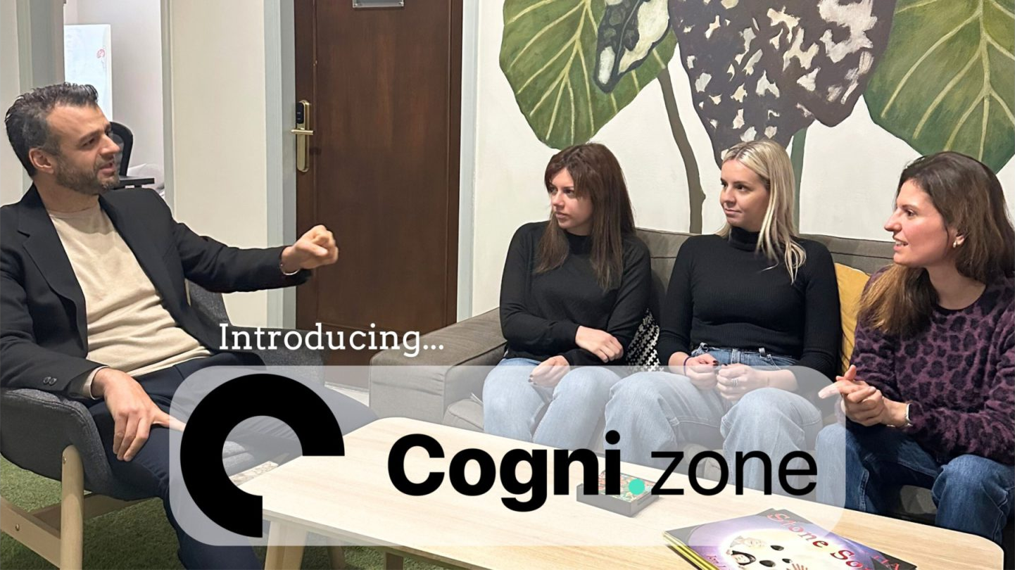 A group of four people having a conversation in a modern lounge area, with the text "Introducing... Cognizone" overlaid in the foreground.