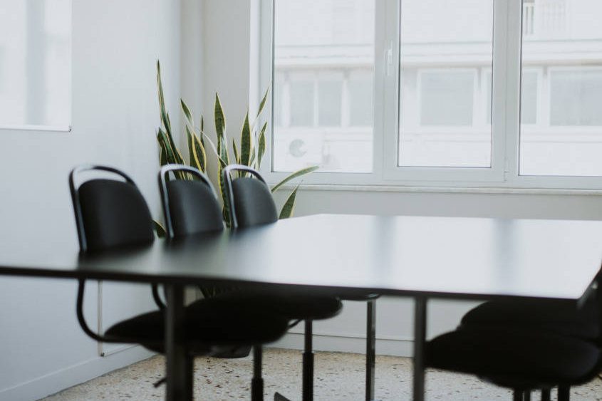A table with chairs in a meeting room.