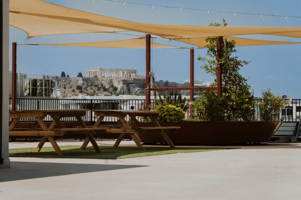 our rooftop view of acropolis with some pic nik tables and plants