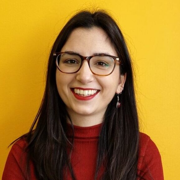 A portrait of a young woman smiling. She is Christina, Stone Soup community manager.